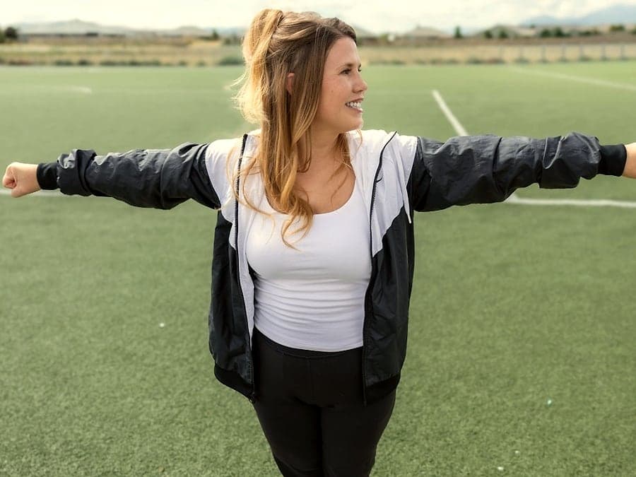 Jacqueline with arms open on the field